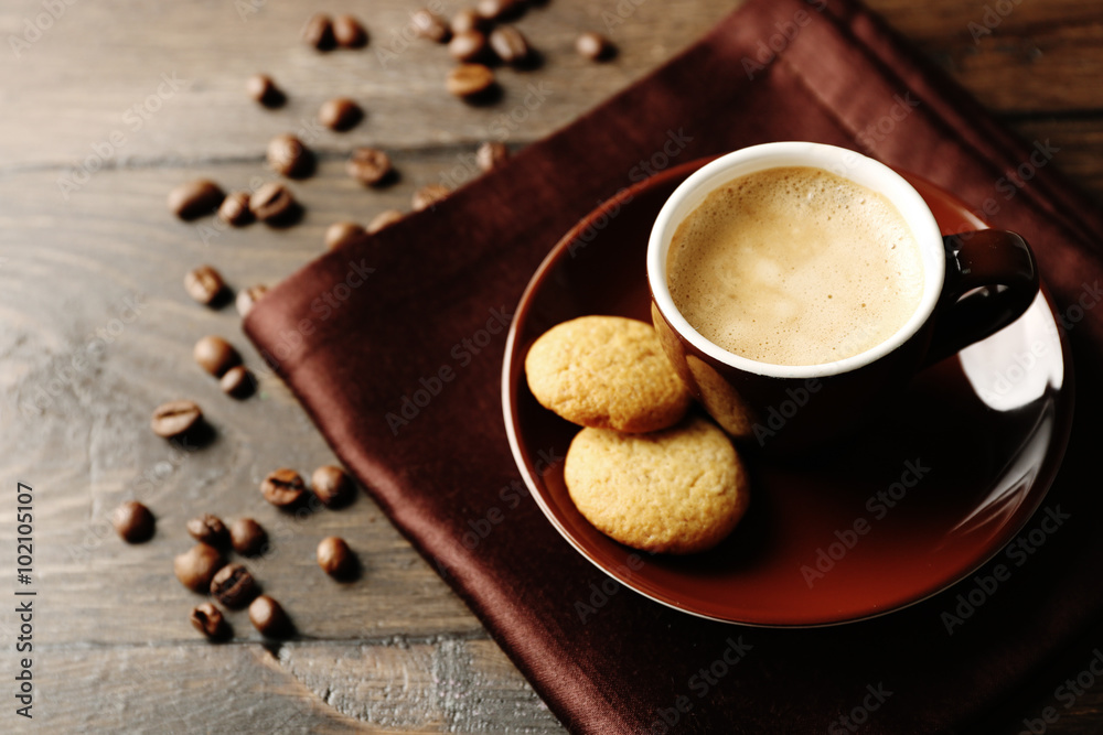 Cup of coffee on wooden table background