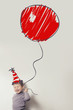 child with an enormous painted balloon