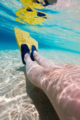 Wall Mural - Underwater photo of  woman legs with fins