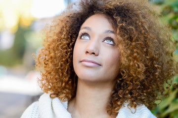 Young African American girl with afro hairstyle and green eyes