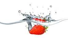 Fresh Strawberry Dropped Into Blue Water With Splash