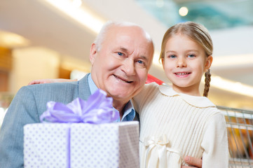 Close-up shot of old grandfather with adorable grandkid