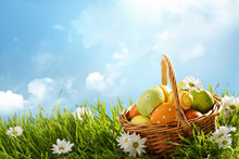 Basket Of Easter Eggs On Green Grass