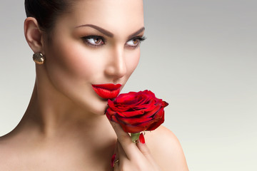 Wall Mural - fashion model girl with red rose in her hand