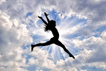 Wall Mural - Silhouette of happy girl jumping