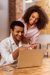 attractive afro-american couple working