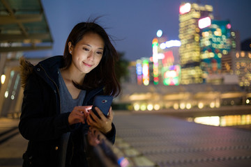 Canvas Print - Woman Using mobile phone at night