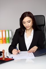 Wall Mural - Brunette woman notary public notarizes the contract