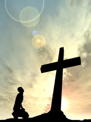 Conceptual religion cross with a man at sunset