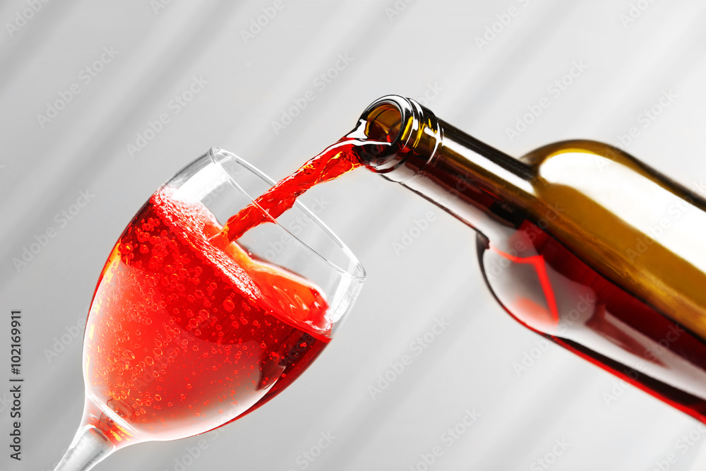 Pouring wine on wall background