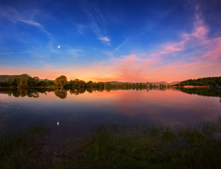 Wall Mural - beautiful night landscape on the mountain lake with stars and reflected clouds in water in spring. c