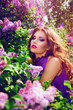 The girl's face. Beautiful girl with flowers. Lilac. Blue dress.