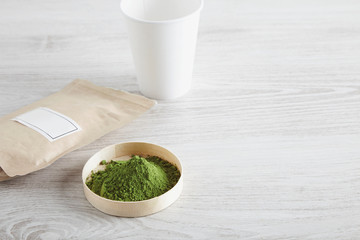 Top view paper bag, glass and matcha tea on white table