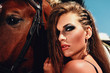 Girl and horse. Horse. rider. Astride a horse. Trendy hairstyles. Beautiful make-up. Beautiful face. Beautiful girl.