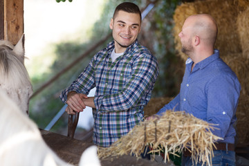 Wall Mural - Two farmers with pitchforks