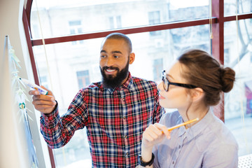 Sticker - Pretty woman and african man preparing for presentation near whiteboard