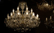 Brass chandelier with crystal. Lighted chandelier with crystal pendants. 