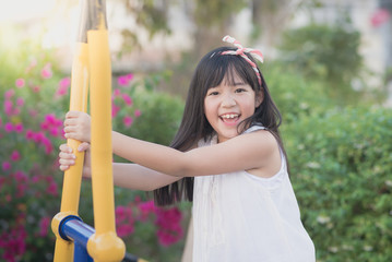 Wall Mural - Happy little girl having fun at the park..