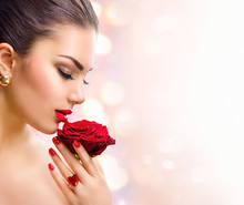 Fashion Model Girl Face Portrait With Red Rose In Her Hand