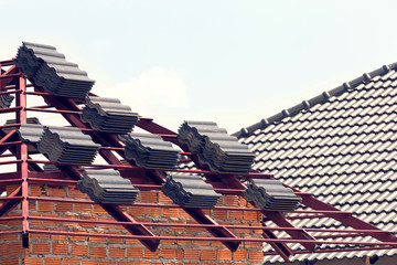 Canvas Print - black tile roof on residential building construction house