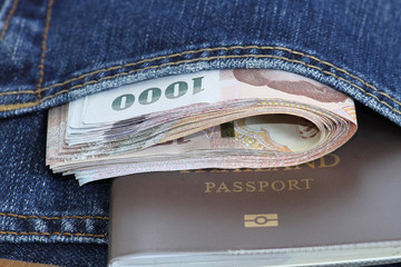 Thailand bank note and passport in the jeans pocket