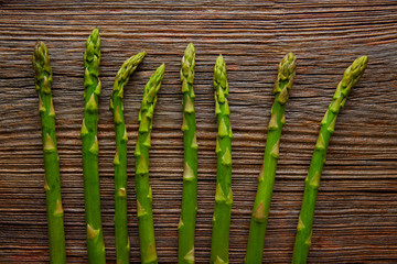 Wall Mural - Asparagus raw vegetables in a row on aged wood