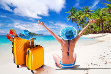 Wall Mural - Woman in hat enjoying sun holidays on the tropical beach