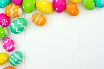 Poster - Colorful Easter egg corner border against a white wood background