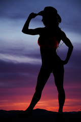 Poster - Silhouette of cowgirl stand side hand on brim of hat