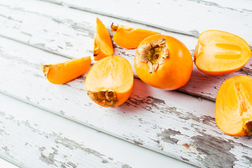 Sticker - Delicious orange persimmons on wooden table