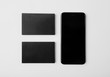 © SFIO CRACHO - Two stack of blank black business cards and smartphone on white background. Horizontal