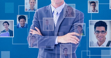 Canvas Print - Composite image of businessman standing with arms crossed