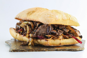 Wall Mural - Tasty beef steak onion mushroom sandwich in a ciabatta 