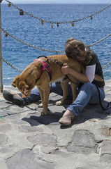 Woman and dog on the coast