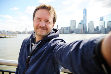 Man making a self portrait skyscrapers in New York City