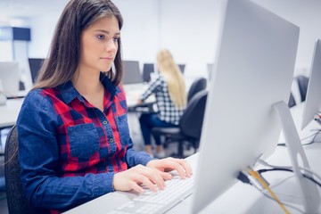 Serious student working on computer 