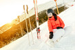 © aboutmomentsimages - Portrait of woman sitting on snow, enjoying the view from mountains