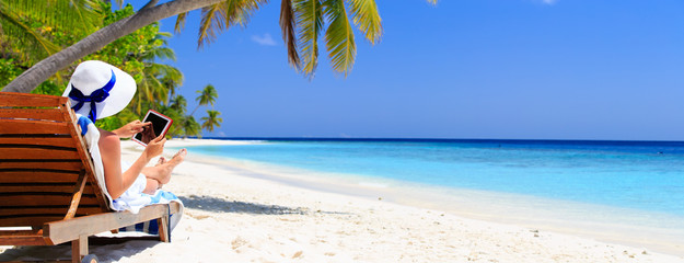 Wall Mural - woman with touch pad on tropical beach