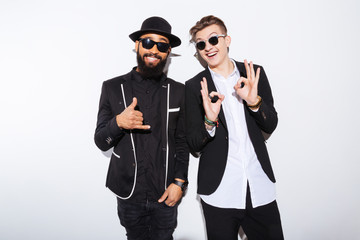 Poster - Two cheerful attractive young men standing and showing ok gesture