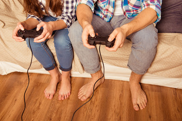 Sticker - Couple in love at home playing video games with joysticks