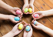 © Syda Productions - close up of woman hands with colored easter eggs