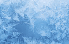 Bright Blue Frost Pattern On A Window Glass (as An Abstract Winter Background)
