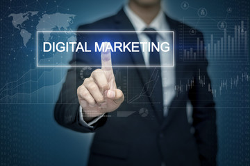 Businessman hand touching DIGITAL MARKETING button on virtual sc