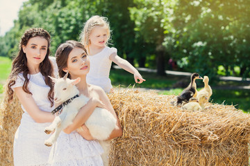 Beautiful girls relaxing in the straw at farm