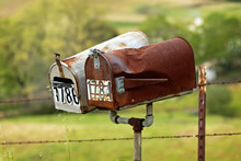Old Country Mailbox Next To A Farm Fence. Old And Rusty, Vintage.