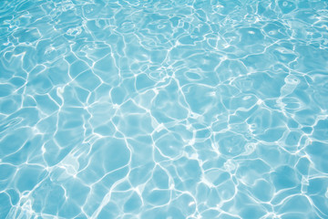 clean and bright water in swimming pool with sun reflection