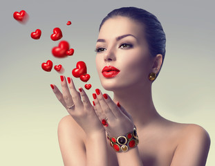 Wall Mural - valentine's day. beauty woman blowing valentine hearts