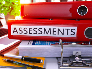 Poster - Red Office Folder with Inscription Assessments on Office Desktop with Office Supplies and Modern Laptop. Assessments Business Concept on Blurred Background. Assessments - Toned Image. 3D
