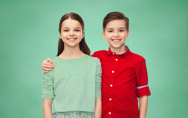 Sticker - happy boy and girl hugging over green chalk board