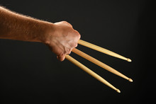 Wolverine Hand With Three Drumsticks Over Black